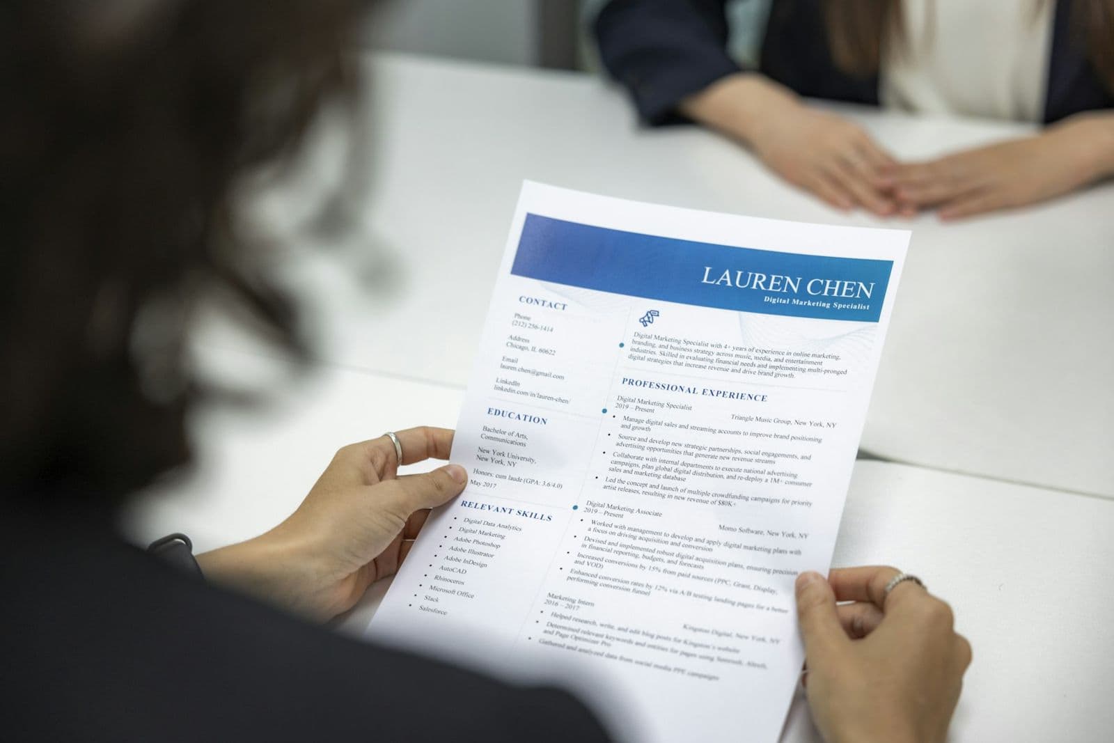 Someone reading through a printed resume